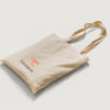 Eco-friendly tote bag with Tamalpais branding, laid flat on white background with handles arranged casually.