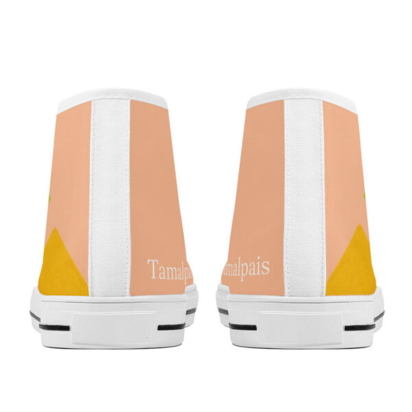 Back view of the 'Pyramids' high-top sneaker by Tamalpais, featuring a soft peach background and abstract yellow mountain shapes.
