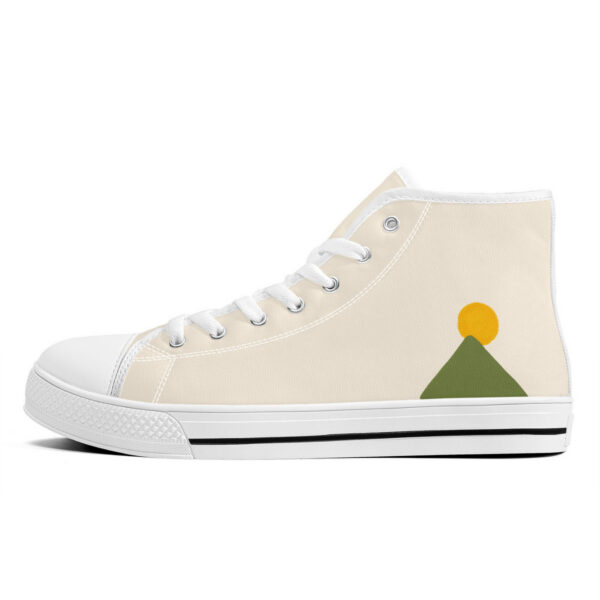 Left outside of “Zénith” sneakers with minimalist green triangle and yellow sun design on cream background.