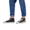 The Etel sneakers worn by a model with rolled-up jeans, showcasing the clean, graphic look of the high-top shoes from both sides.