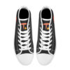 Top-down view of the Etel sneakers, showing white laces, black tongue, and a bold abstract 'T' logo in warm tones on the insole.